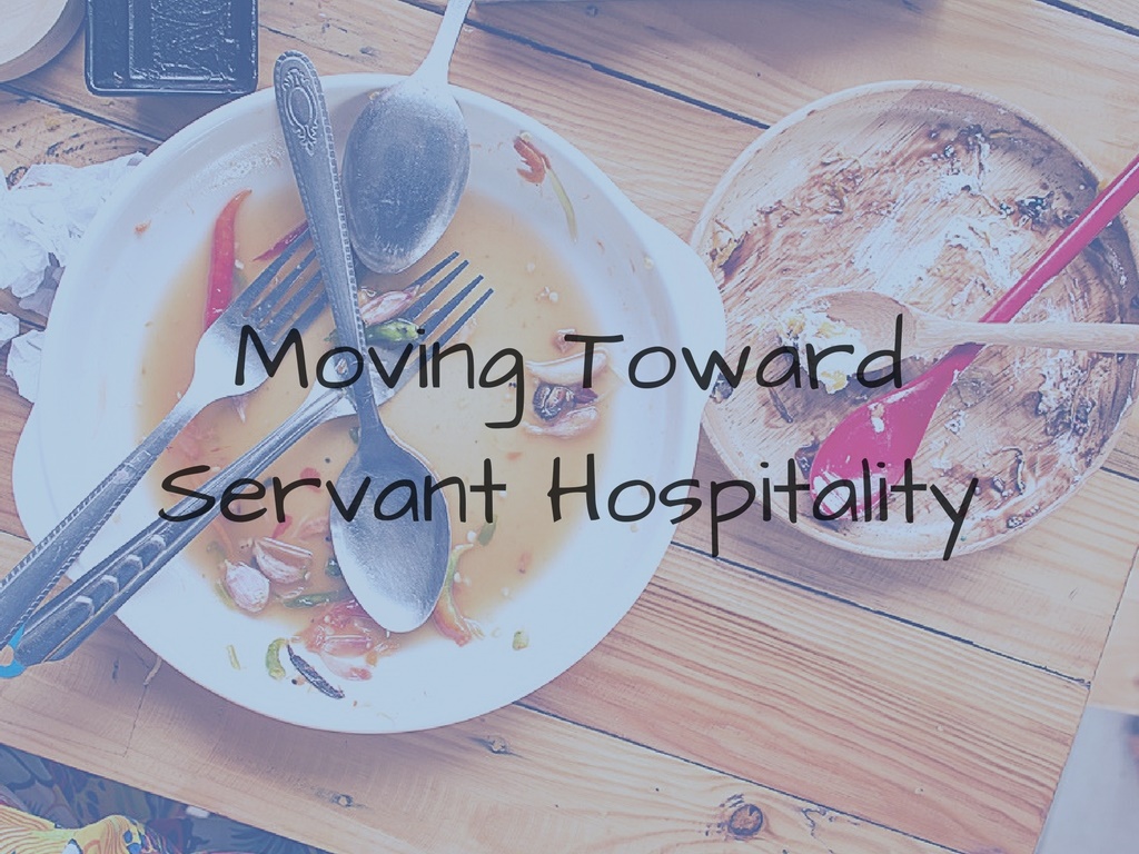 moving toward servant hospitality - dirty plates on wooden table